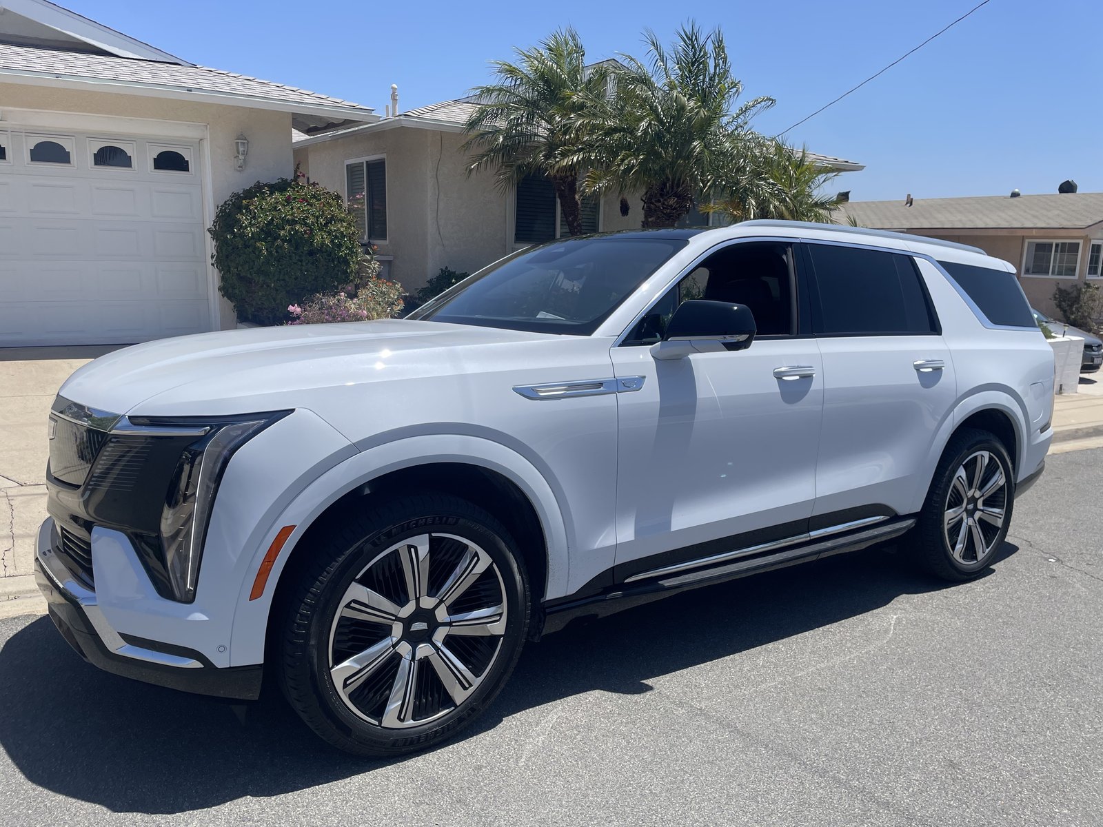 Cadillac Escalade IQ-L electric luxury SUV at a San Diego pickup — Elite Green Transportation fleet vehicle